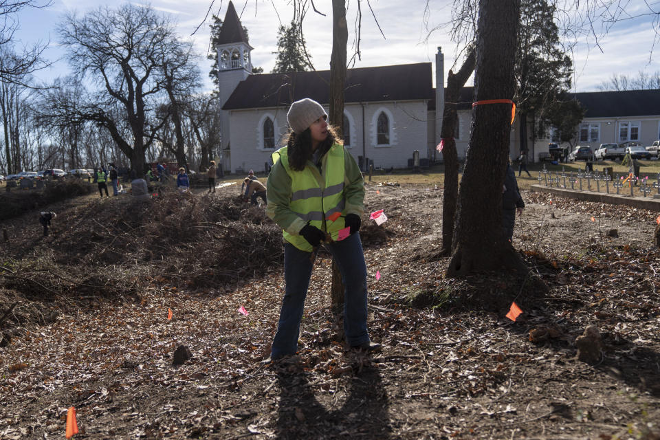 Descendants and student volunteers, including Dr. Laura Masur, an assistant professor of anthropology at Catholic University, gathered at the cemetery of a church to help clear brush from a site where graves have been found  in Bowie, Maryland, on Jan. 16, 2023. The graves are believed to be of enslaved persons. / Credit: Michael Robinson Chavez/The Washington Post via Getty Images