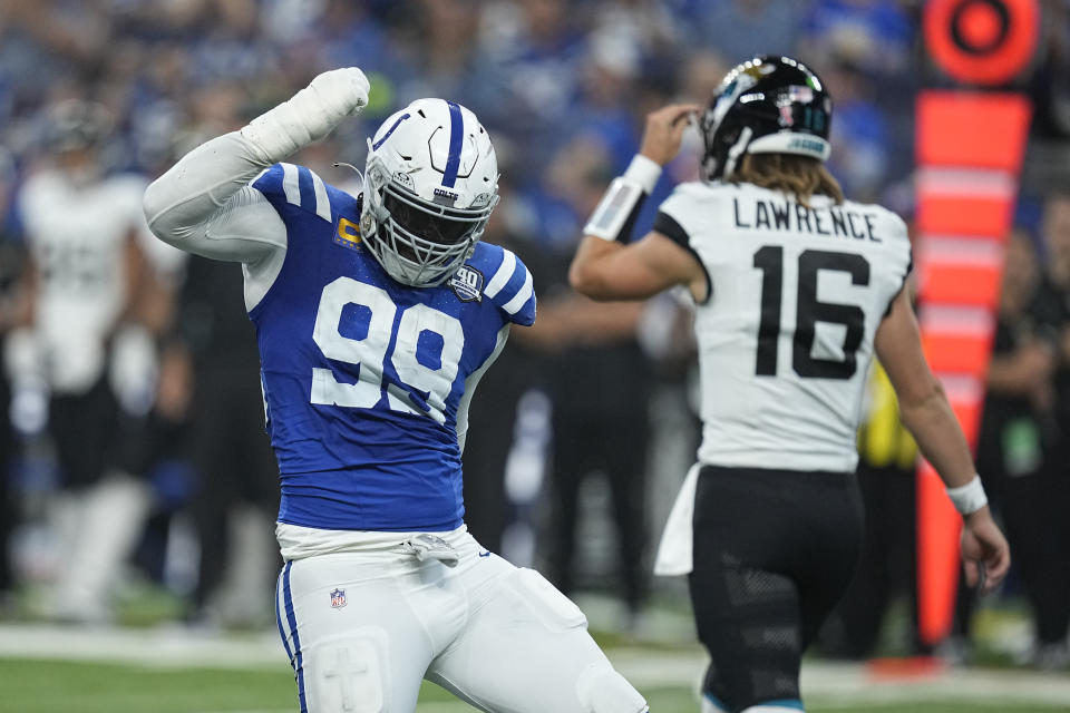 Indianapolis Colts defensive tackle DeForest Buckner (99) celebrates as Jacksonville Jaguars quarterback Trevor Lawrence (16) walks in the background during the first half of an NFL football game Sunday, Sept. 10, 2023, in Indianapolis. (AP Photo/Darron Cummings)