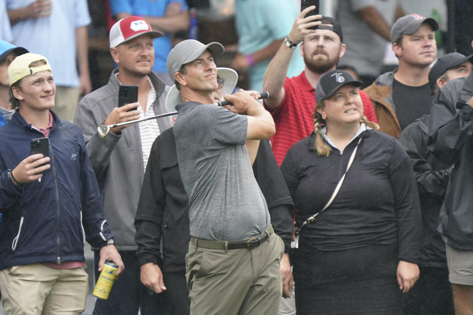 Adam Scott, of Australia, chips to the ninth green during the first round of the Wyndham Championship golf tournament in Greensboro, N.C., Thursday, Aug. 3, 2023. (AP Photo/Chuck Burton)