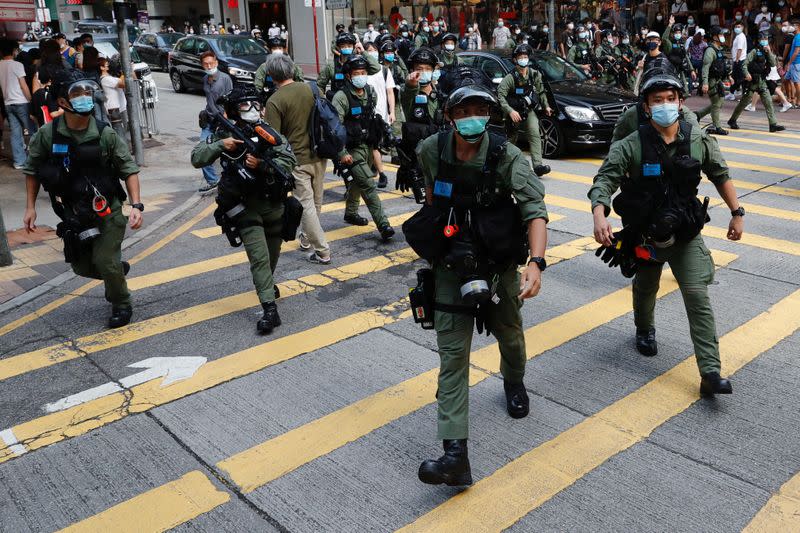 Riot police disperse pro-democracy protesters during a demonstration oppose postponed elections, in Hong Kong