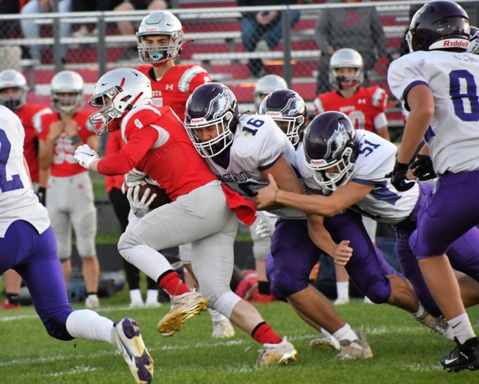 Marshwood’s Justin Farnham (16) and Treyton Lauber (51) team up to drag down South Portland’s Jonathan Poole during Class B football action Friday, Sept. 2, 2022, in South Portland, Maine.