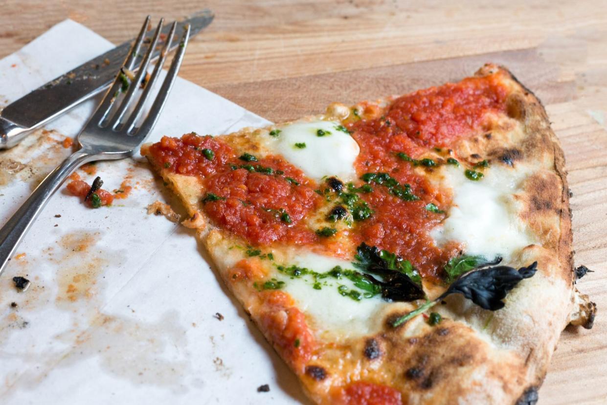 Close-Up Of Pizza Slice On Table