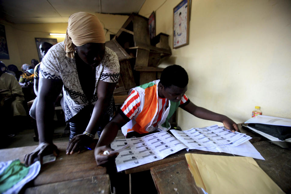 People wait in line to vote in presidential election in Abidjan, Ivory Coast, Saturday, Oct. 31, 2020. Tens of thousands of security forces deployed across Ivory Coast on Saturday as the leading opposition parties boycotted the election, calling President Alassane Ouattara's bid for a third term illegal. (AP Photo/Diomande Ble Blonde)