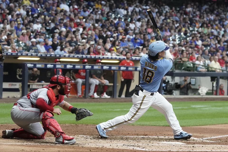 Milwaukee Brewers' Keston Hiura hits a two-run home run during the fourth inning of a baseball game against the Cincinnati Reds Saturday, Aug. 6, 2022, in Milwaukee. (AP Photo/Morry Gash)