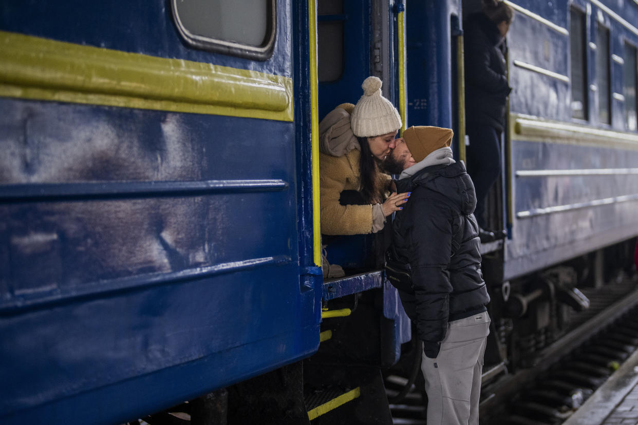 Stanislav kisses wife Anna before she leaves on a train in Kyiv on Thursday. 