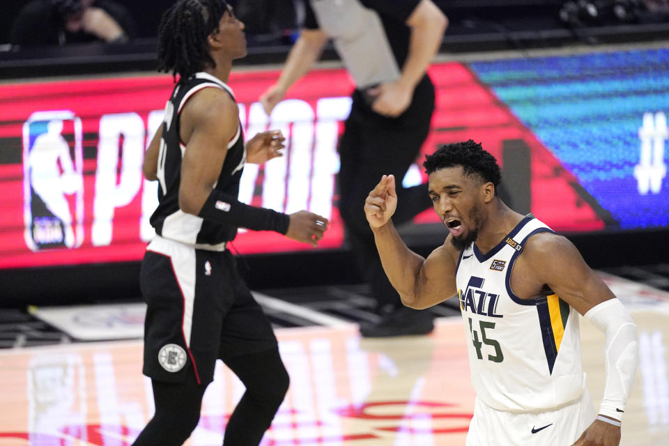 Utah Jazz guard Donovan Mitchell, right, reacts after a Los Angeles Clippers turnover as guard Terance Mann runs by during the second half in Game 6 of a second-round NBA basketball playoff series Friday, June 18, 2021, in Los Angeles. (AP Photo/Mark J. Terrill)