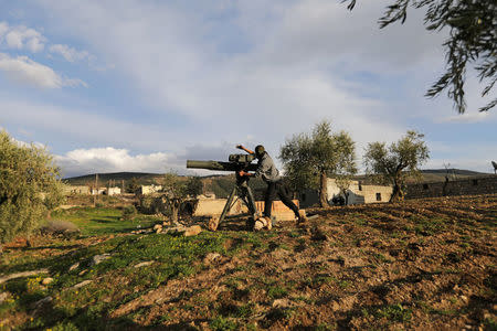 Turkish-backed Free Syrian Army fighter uses a TOW anti-tank missile north of the city of Afrin, Syria, February 18, 2018. REUTERS/Khalil Ashawi