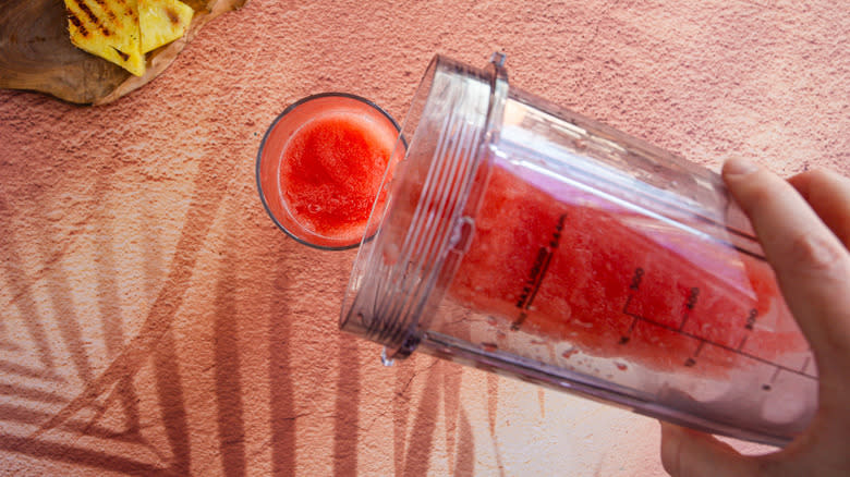 Pouring red mixture into glass