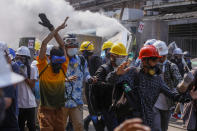 FILE - In this March 11, 2021, file photo, anti-coup protesters retreat from the frontlines after policemen fire sound-bombs and fire with rubber bullets in Yangon, Myanmar. U.N. Secretary-General Antonio Guterres bracketed Myanmar with Afghanistan and Ethiopia as nations for whose people “peace and stability remain a distant dream" in a speech last Tuesday, Sept. 21, 2021, to open the annual U.N. General Assembly. (AP Photo/File)