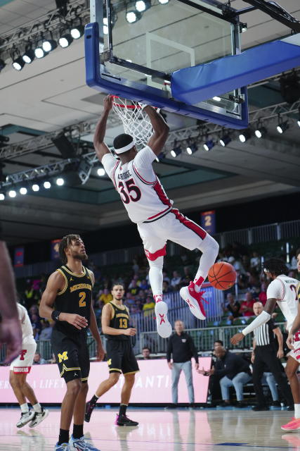 In a photo provided by Bahamas Visual Services, Texas Tech's Devan Cambridge (35) dunks during an NCAA college basketball game against Michigan in the Battle 4 Atlantis at Paradise Island, Bahamas, Friday, Nov. 24, 2023. (Ronnie Archer/Bahamas Visual Services via AP)