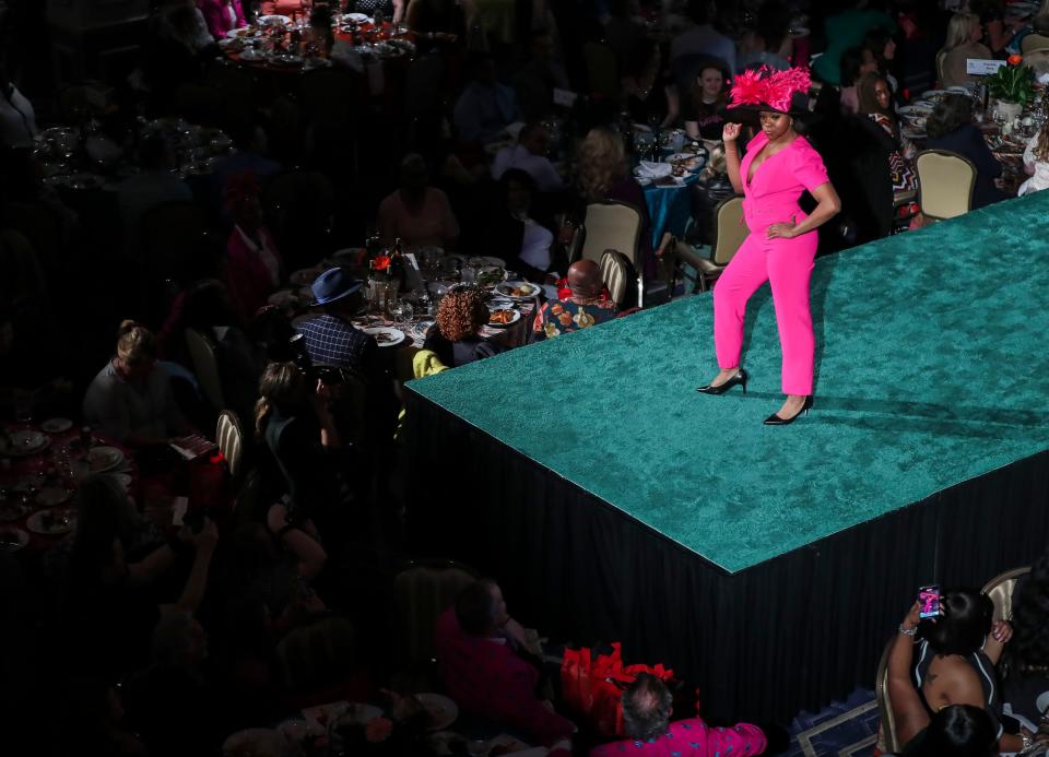 A model poses on the runway in a pink hat and suit at the 2022 Kentucky Derby Festival and Macy's Spring Fashion Show at Caesars Southern Indiana Casino in Elizabeth, Indiana, March 31, 2022. "I describe the colors of the season as 'solar-powered,'" said fashion show creative consultant Christine Fellingham. "I mean beautiful bright colors you'd see in a fantastic sunrise or sunset."