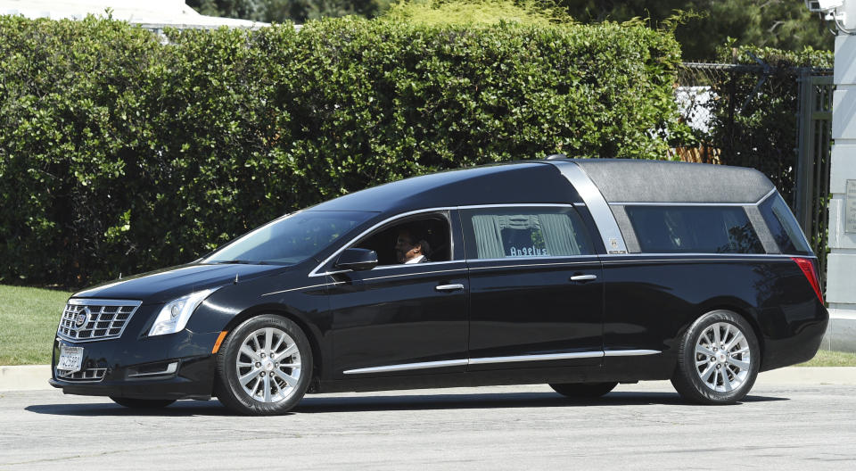 A hearse leaves a burial service for the late rapper Nipsey Hussle at Forest Lawn Hollywood Hills cemetery, Friday, April 12, 2019, in Los Angeles. (Photo by Chris Pizzello/Invision/AP)