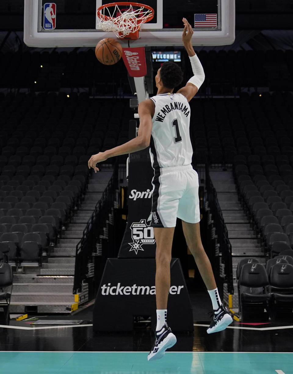 San Antonio Spurs' Victor Wembanyama, the No. 1 draft pick, makes a basket during an NBA basketball press conference, Saturday, June 24, 2023, at the AT&T Center in San Antonio. (AP Photo/Eric Gay)