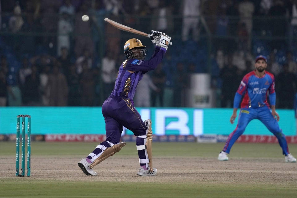 Quetta Gladiators' Sherfane Rutherford, left, plays a shot during the Pakistan Super League T20 cricket match between Karachi Kings and Quetta Gladiators, in Karachi, Pakistan, Thursday, Feb. 29, 2024. (AP Photo/Fareed Khan)