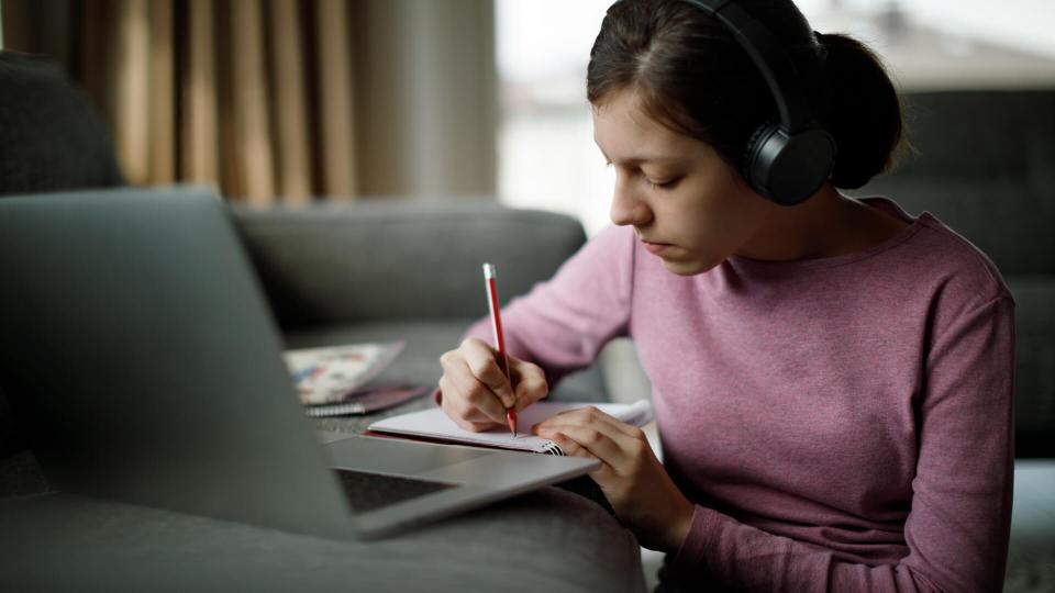 girl taking notes for video interview