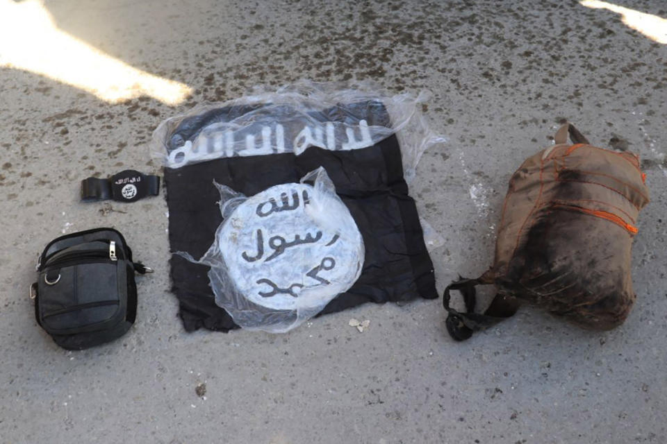 FILE - This photo provided by the Kurdish-led Syrian Democratic Forces shows the flag and bags of Islamic State group fighters who were arrested by the Kurdish-led Syrian Democratic Forces after they attacked Gweiran Prison, in Hassakeh, northeast Syria, Friday, Jan. 21, 2022. With a spectacular jail break in Syria and a deadly attack on an army barracks in Iraq, the Islamic State group was back in the headlines the past week, a reminder of a war that formally ended three years ago but continues to be waged away from view. (Kurdish-led Syrian Democratic Forces, via AP, File)