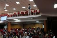 A Taliban fighter stands guard at a news conference about a new command of hijab by Taliban leader Mullah Haibatullah Akhundzada, in Kabul