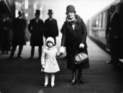 <p>A 3-year-old Princess Elizabeth holds her grandmother's hand at King's Cross station on December 21, 1929. They were traveling to Sandringham Estate for the holidays.</p>