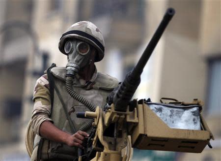 A soldier rides on an armoured personnel carrier (APC) at Tahrir Square after clashes with pro-Mursi protesters in Cairo December 1, 2013. REUTERS/Amr Abdallah Dalsh