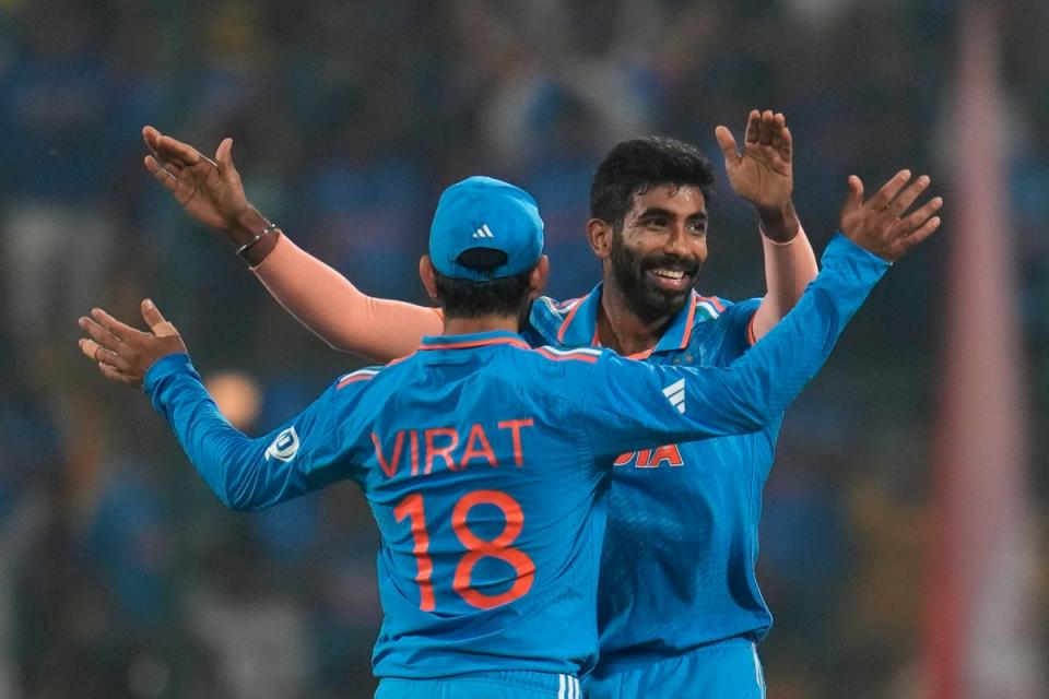 India's Jasprit Bumrah, right, and Virat Kohli celebrates the dismissal of Netherlands' Bas De Leede (AP)