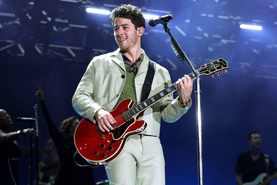 <p>Kevin Mazur/Getty Images</p> Nick Jonas performs in New York City on Aug. 13