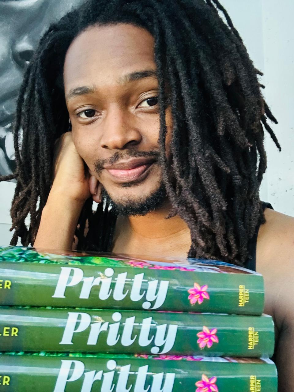 Novelist and Savannah native Keith F. Miller poses with copies of his debut book "Pritty," He wrote the novel over a period of roughly 14 years before Harper Collins secured it for publication. Miller is currently finalizing edits on the sequel.