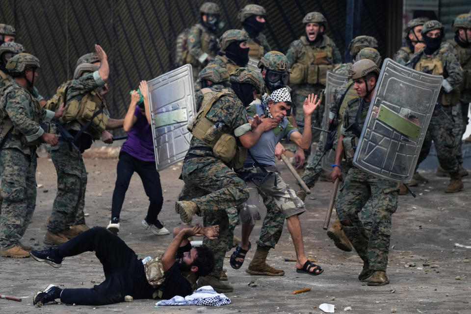 Lebanese army soldiers scuffle with protesters during a demonstration, in solidarity with the Palestinian people in Gaza, near the U.S. embassy in Aukar, a northern suburb of Beirut, Lebanon, Wednesday, Oct. 18, 2023. Hundreds of angry protesters are clashing with Lebanese security forces in the Lebanese suburb Aukar near the United States Embassy. (AP Photo/Hassan Ammar)