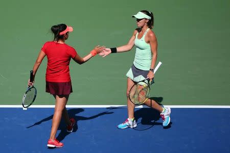 Sep 13, 2015; New York, NY, USA; Martina Hingis of Switzerland and Sania Mirza of India celebrate a point against Casey Dellacqua of Australia and Yaroslava Shvedova of Kazakhstan in the Women's Doubles Final on day fourteen of the 2015 U.S. Open tennis tournament at USTA Billie Jean King National Tennis Center. Anthony Gruppuso-USA TODAY Sports