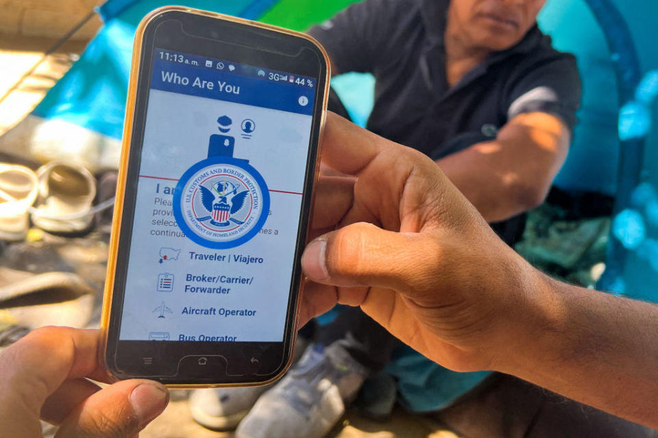 A migrant shows the CBP One app from Customs and Border Protection, which is used to apply for an appointment to claim asylum, in Ciudad Juárez, Mexico, on May 10, 2023. / Credit: GILLES CLARENNE/AFP via Getty Images