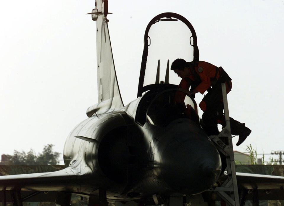 A Taiwan air force pilot climbs into a French-made Mirage fighter at an airbase in Hsinchu January 21, 2003 during a routine military drill ahead of the Lunar New Year holidays, which falls on February 1.