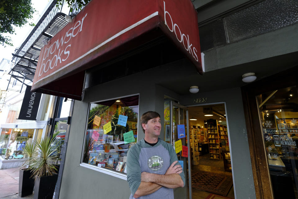 In this Wednesday, Dec. 4, 2019, photo Pete Mulvihill poses for a photo while standing outside at his Browser Books store that he recently opened in San Francisco. Mulvihill has felt optimistic enough about being an independent bookseller that he bought a third store within the past two months. (AP Photo/Eric Risberg)