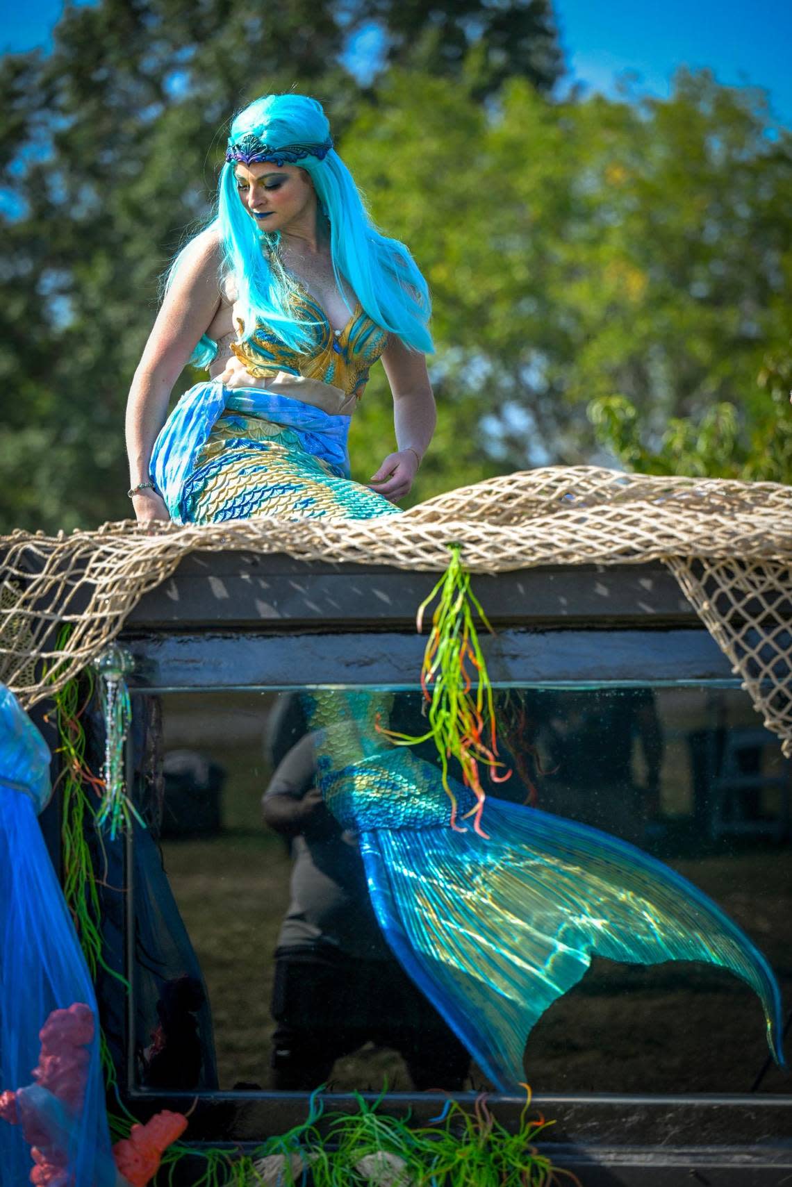 In character as Mermaid Bonnie, Valery Magner gets positioned atop the mermaid tank before the promotional video shoot.