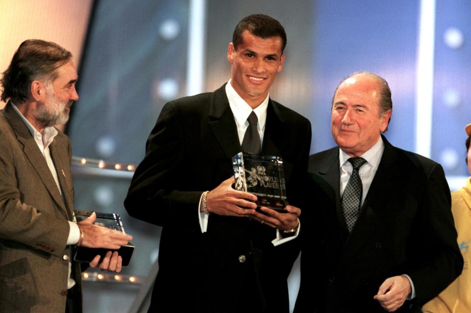 Rivaldo of Brazil and Barcelona (c) receives the FIFA World Player of the Year Award Trophy in Brussels from FIFA President Joseph Sepp Blatter (r) watched by George Best (l), who received David Beckham's runners up prize (Photo by Tony Marshall/EMPICS via Getty Images)