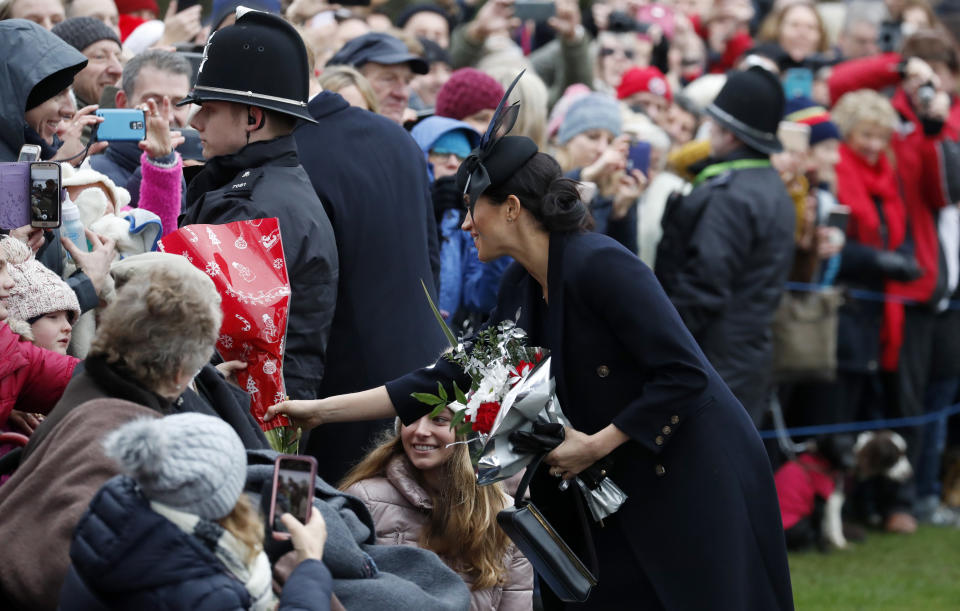 Britain's Meghan, Duchess of Sussex meets members of the crowd after attending the Christmas day service at St Mary Magdalene Church in Sandringham in Norfolk, England, Tuesday, Dec. 25, 2018. (AP Photo/Frank Augstein)