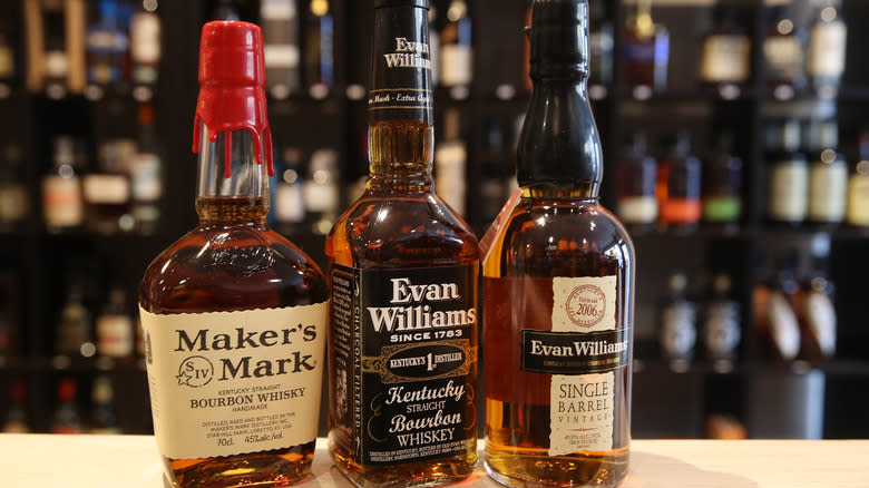 Three bourbon bottles on bar counter 