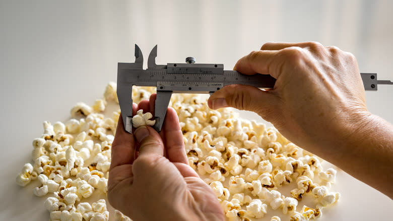 hand measuring popcorn