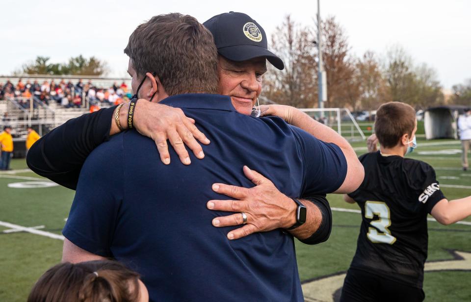 Sacred Heart-Griffin head football coach Ken Leonard hugs his son, Rochester head football coach Derek Leonard as the Cyclones get set to take on the Rockets at Ken Leonard Field in Springfield, Ill., Friday, April 9, 2021. [Justin L. Fowler/The State Journal-Register] 