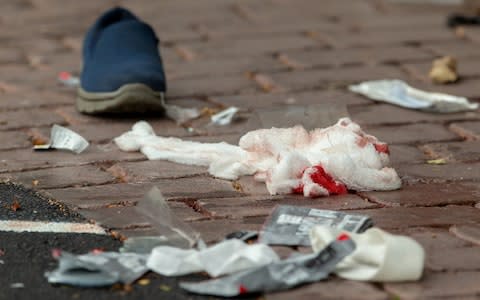Bloodied bandages on the road following a shooting at the Al Noor mosque in Christchurch - Credit: REUTERS