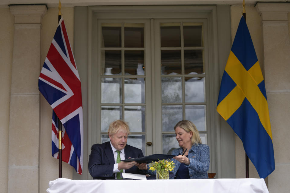 FILE - British Prime Minister Boris Johnson, left, and Sweden's Prime Minister Magdalena Andersson exchange files as they sign a security assurance, in Harpsund, the country retreat of Swedish prime ministers, Wednesday, May 11, 2022. Finland appears on the cusp of joining NATO. Sweden could follow suit. By year’s end, they could stand among the alliance’s ranks. Russia’s war in Ukraine has provoked a public about face on membership in the two Nordic countries. They are already NATO’s closest partners, but should Russia respond to their membership moves they might soon need the organization’s military support. (AP Photo/Frank Augstein, Pool, File)