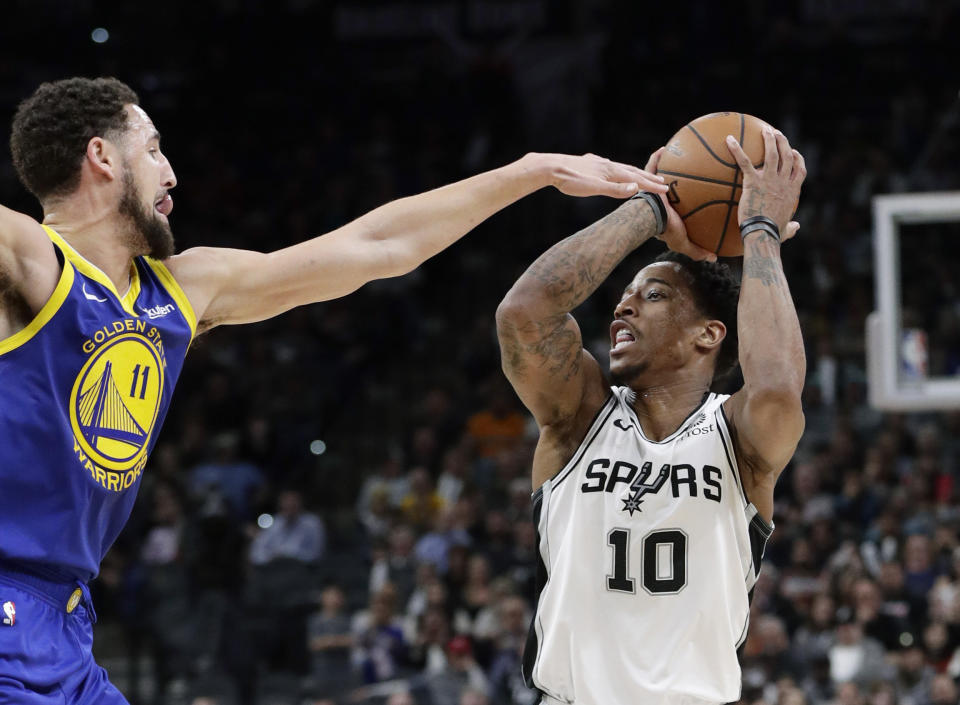 San Antonio Spurs guard DeMar DeRozan (10) shoots against Golden State Warriors guard Klay Thompson (11) during the second half of an NBA basketball game in San Antonio, Monday, March 18, 2019. (AP Photo/Eric Gay)