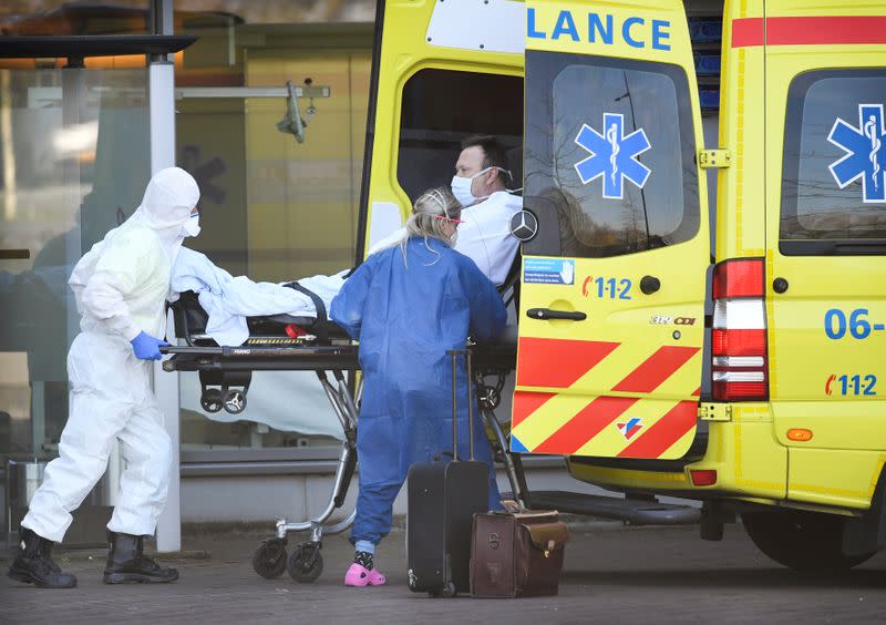 FILE PHOTO: Dutch health workers leave with a patient at Bernhoven hospital, as the spread of coronavirus disease (COVID-19) continues, in Uden