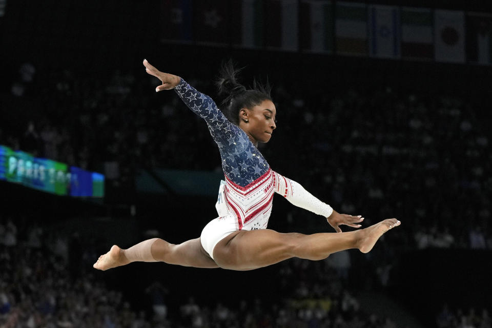 Biles vaults the balance beam at the 2024 Summer Olympics.