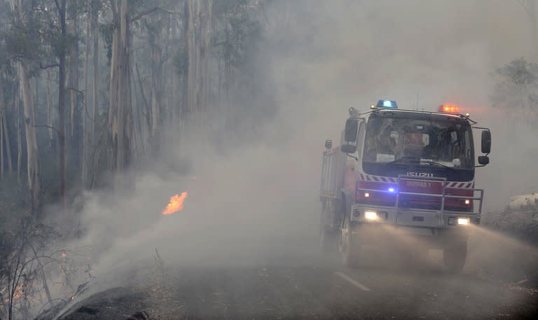 New South Wales state fire crews drive through the smoke from the Kilmore East-Murrindini North fire on March 3, 2009. The Kilmore East blaze was the largest of the "Black Saturday" February 2009 wildfires in southern Victoria state that left 173 dead and razed more than 2,000 homes, the nation's worst natural disaster of modern times