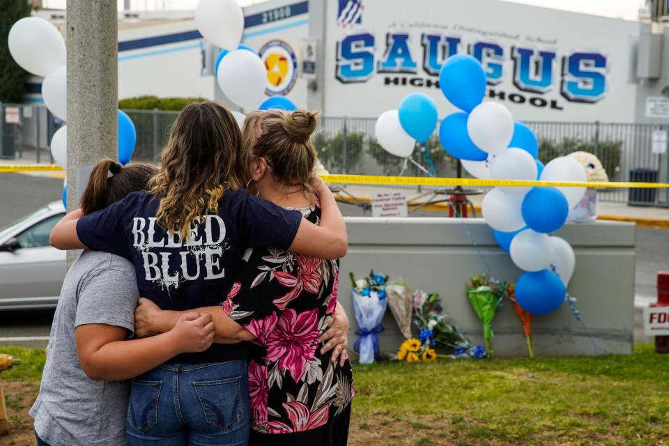 Saugus High School freshman Haley Stuart hugs her family at a memorial at Saugus High School on Nov. 15, 2019.