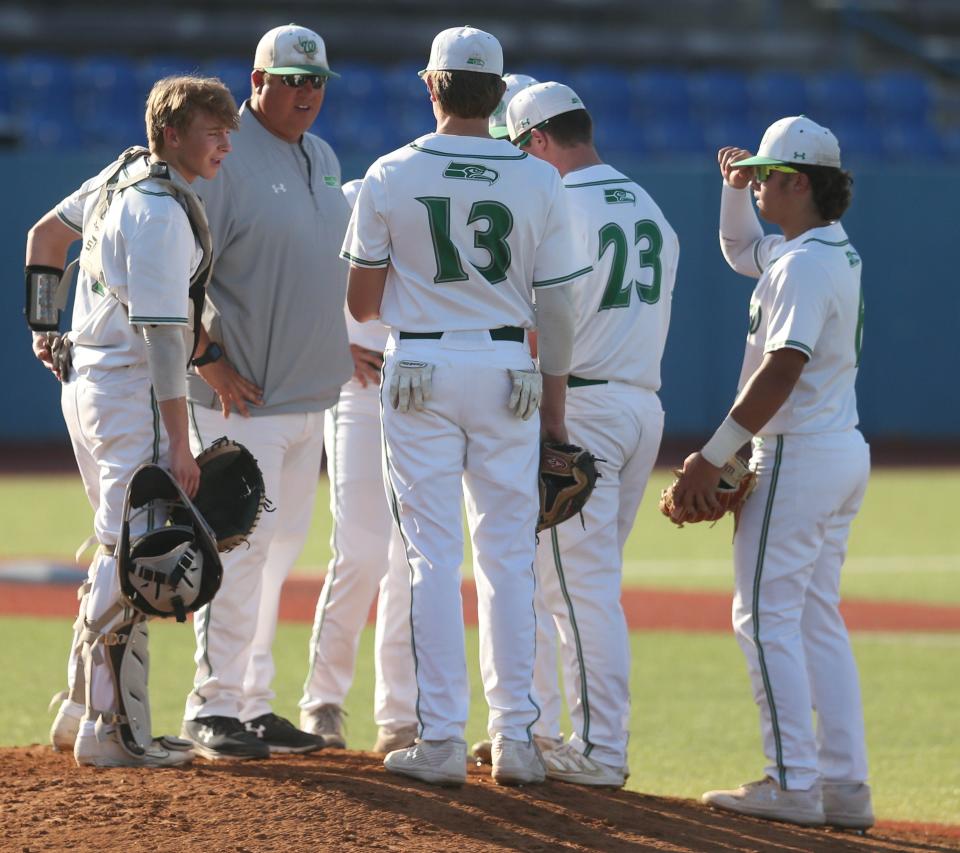 Wall High School head baseball coach Jason Schniers has a meeting on the mound with the Hawks during the District 6-3A championship against Jim Ned at Angelo State University's Foster Field at 1st Community Credit Union Stadium on Monday, May 2, 2022.