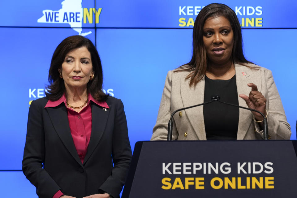 New York Gov. Kathy Hochul, left, listens as Attorney General Letitia James speak during a news conference in New York, Wednesday, Oct. 11, 2023. New York is bidding to put new controls on social media platforms that state leaders say will protect the mental health of younger users. (AP Photo/Seth Wenig)