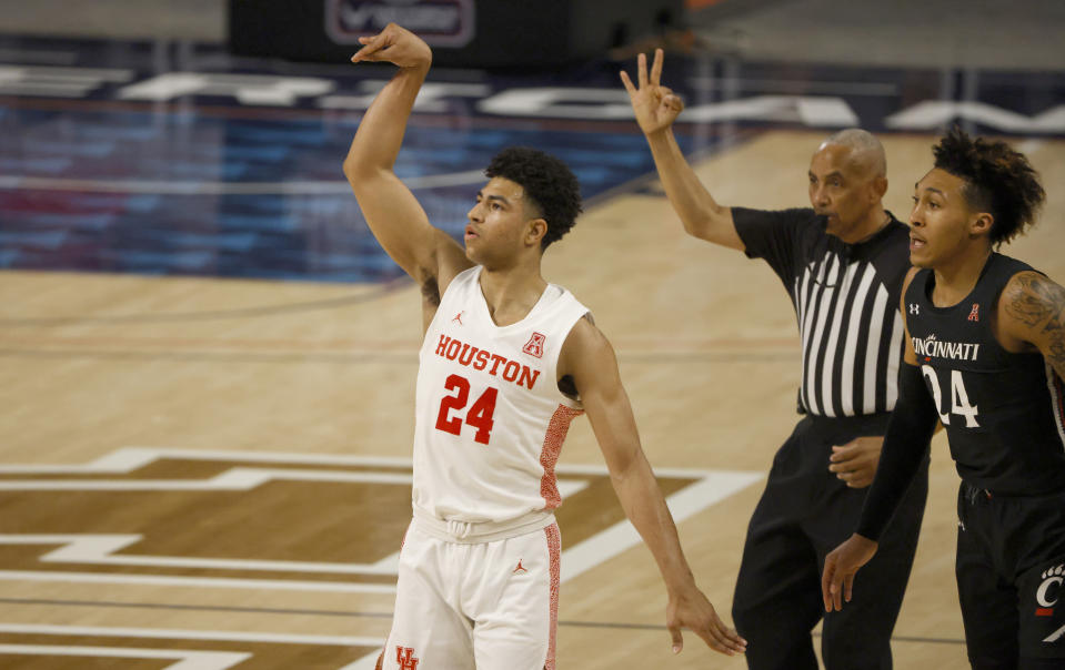 Houston guard Quentin Grimes (24) attempts a 3-point shot as Cincinnati guard Jeremiah Davenport (24) looks on during the first half of an NCAA college basketball game in the final round of the American Athletic Conference men's tournament Sunday, March 14, 2021, in Fort Worth, Texas. (AP Photo/Ron Jenkins)