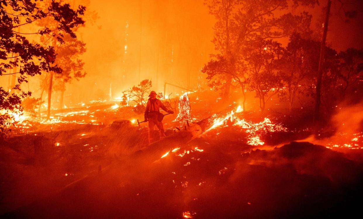 <span class="caption">The 2020 wildfire season has been shattering records across the West.</span> <span class="attribution"><a class="link " href="https://www.gettyimages.com/detail/news-photo/firefighter-works-the-scene-as-flames-push-towards-homes-news-photo/1228385733" rel="nofollow noopener" target="_blank" data-ylk="slk:Josh Edelson/AFP via Getty Images;elm:context_link;itc:0;sec:content-canvas">Josh Edelson/AFP via Getty Images</a></span>