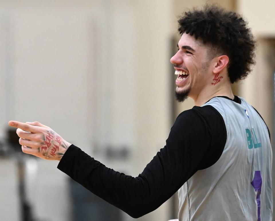 Charlotte Hornets guard LaMelo Ball jokes with a coach during practice on Thursday, November 16, 2023. Ball just got a new tattoo under his left ear and the NBA is requiring him to cover it during games due to NBA marketing rules.