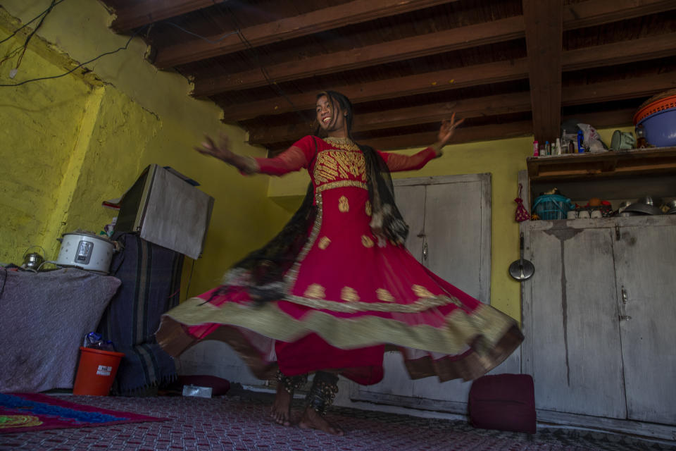 A transgender Kashmiri Maliaka Sheikh, in tradition attire of Kashmiri dancers, poses for photographs inside the home of a friend on the outskirts of Srinagar, Indian controlled Kashmir, Thursday, June 3, 2021. The 22-year-old transgender left home as an 11-year-old and started living with other transgenders. "At the beginning it was difficult for my family to understand me but fortunately, they have now accepted me for who I am," Maliaka said. (AP Photo/ Dar Yasin)